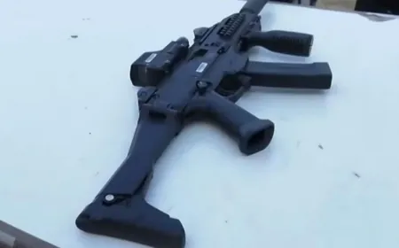 كتائب القسام تضع قطعة سلاح إسرائيلية اغتنمها مقاتلوها من جنود الاحتلال على طاولة تسليم المجندة في شمال غزة.